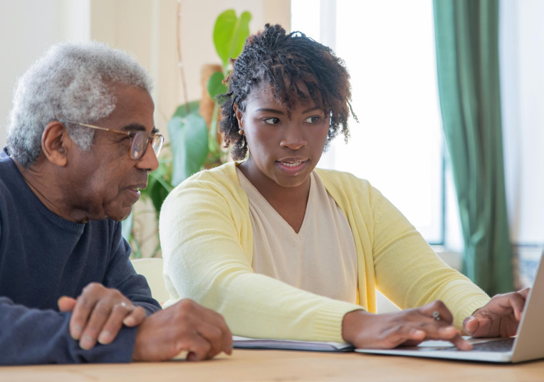 2 people sitting in front of a computer