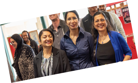 3 Women in corporate attire smiling at the camera
